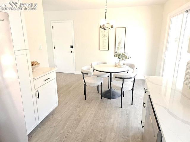 910 Dunston St, Colorado Springs, CO 80907 - dining space with a chandelier, light wood-type flooring, and baseboards