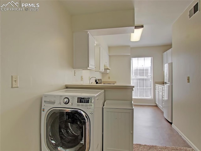 3425 Rebecca Ln Unit H, Colorado Springs, CO 80917 - washroom featuring washer / clothes dryer, cabinet space, and baseboards