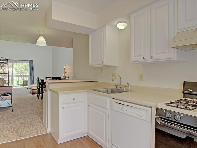 3425 Rebecca Ln Unit H, Colorado Springs, CO 80917 - kitchen with dishwasher, gas range oven, a sink, a peninsula, and premium range hood