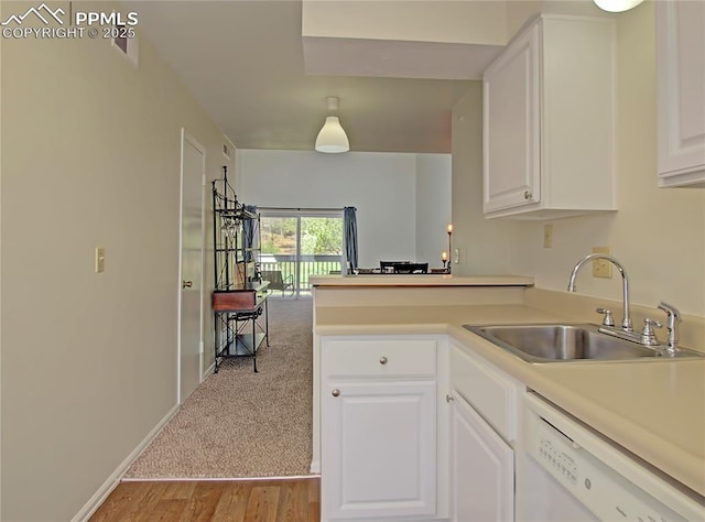 3425 Rebecca Ln Unit H, Colorado Springs, CO 80917 - kitchen with white dishwasher, a sink, a peninsula, white cabinetry, and light countertops