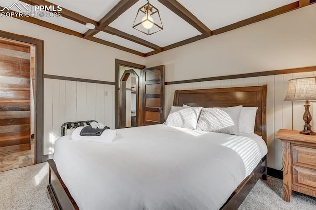 carpeted bedroom featuring a wainscoted wall