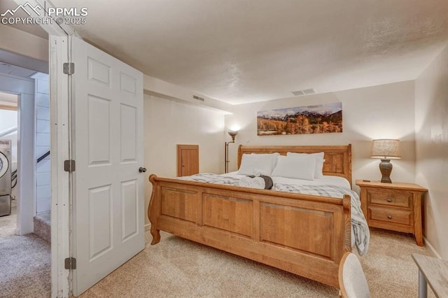 bedroom featuring light colored carpet