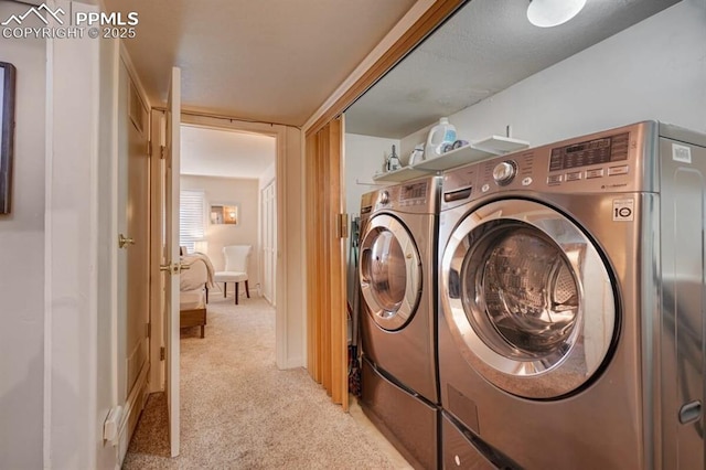 washroom featuring light carpet and independent washer and dryer