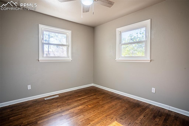 1701 Grant Ave, Colorado Springs, CO 80909 - unfurnished room featuring plenty of natural light, baseboards, ceiling fan, and dark wood-style flooring