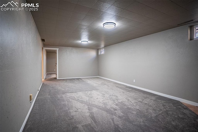 1701 Grant Ave, Colorado Springs, CO 80909 - basement with carpet flooring, a textured wall, and baseboards