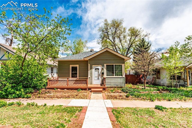427 N Walnut St, Colorado Springs, CO 80907 - bungalow-style house featuring a wooden deck, fence, and a shingled roof