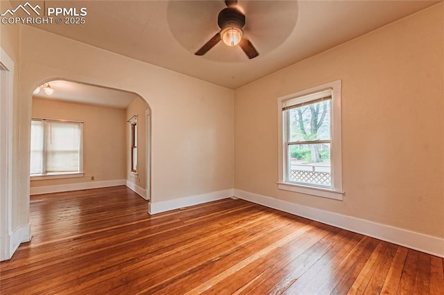 427 N Walnut St, Colorado Springs, CO 80907 - empty room featuring hardwood / wood-style floors, arched walkways, baseboards, and ceiling fan