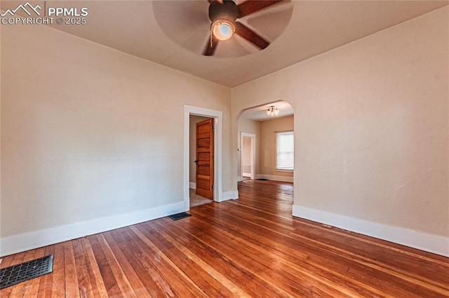 427 N Walnut St, Colorado Springs, CO 80907 - unfurnished room with arched walkways, ceiling fan, baseboards, and wood-type flooring