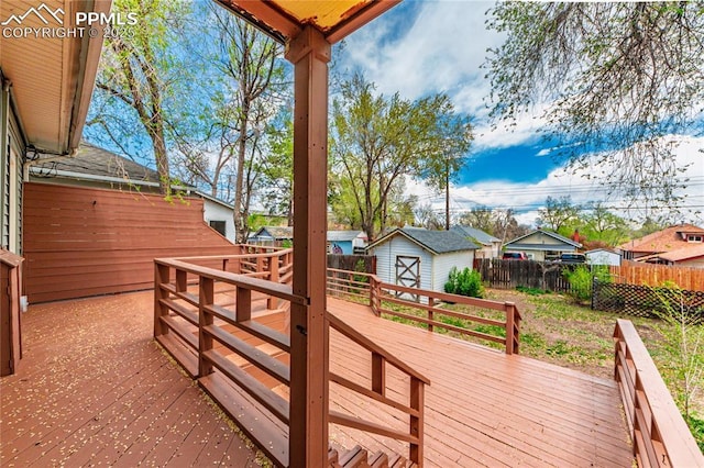 427 N Walnut St, Colorado Springs, CO 80907 - wooden deck with a fenced backyard, a storage unit, and an outbuilding