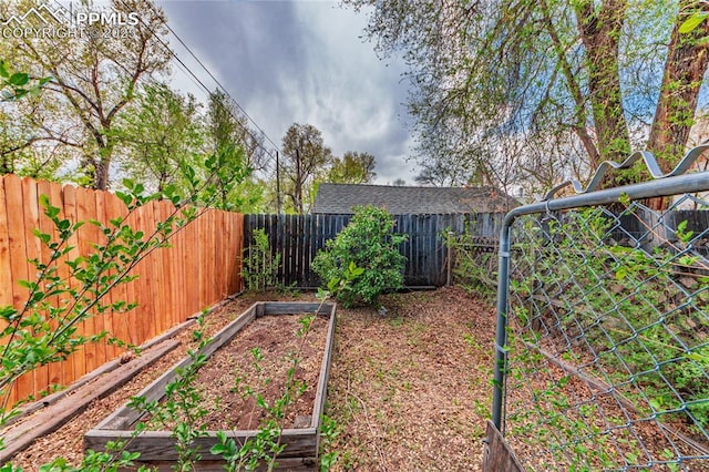 427 N Walnut St, Colorado Springs, CO 80907 - fenced backyard featuring a vegetable garden