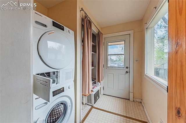 427 N Walnut St, Colorado Springs, CO 80907 - washroom with stacked washer / drying machine, tile patterned flooring, and baseboards