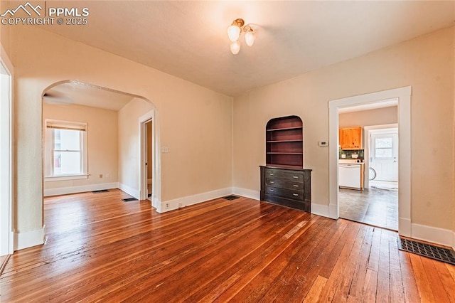 427 N Walnut St, Colorado Springs, CO 80907 - spare room with arched walkways, wood-type flooring, and baseboards