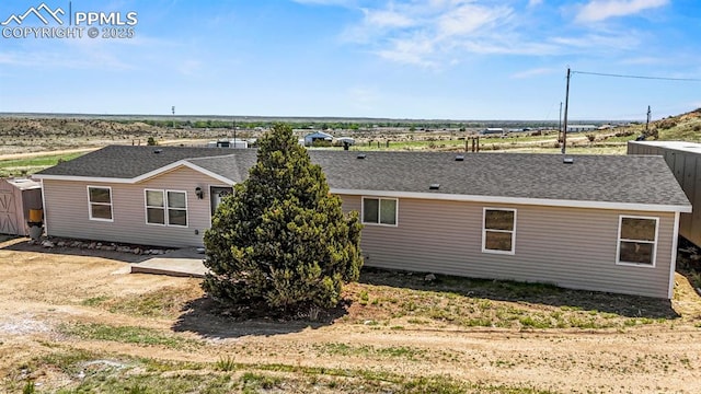 9775 Indian Village Hts, Fountain, CO 80817 - back of house featuring a storage unit, a shingled roof, and an outbuilding