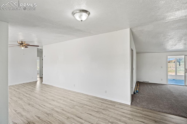 9775 Indian Village Hts, Fountain, CO 80817 - empty room with a textured ceiling, wood finished floors, a ceiling fan, and baseboards