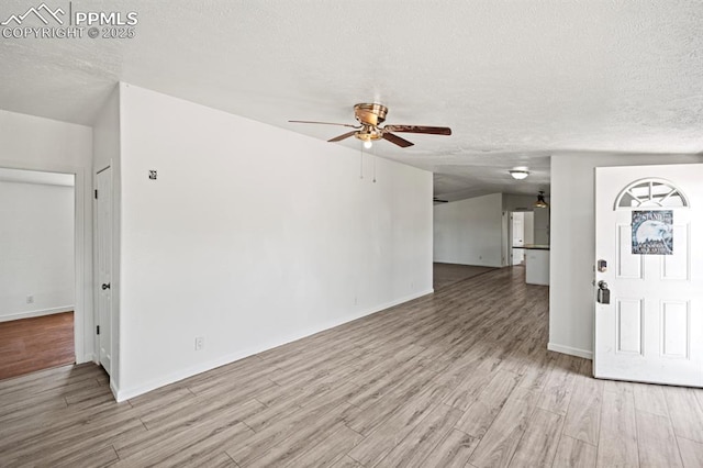9775 Indian Village Hts, Fountain, CO 80817 - foyer featuring a textured ceiling, a ceiling fan, wood finished floors, and baseboards