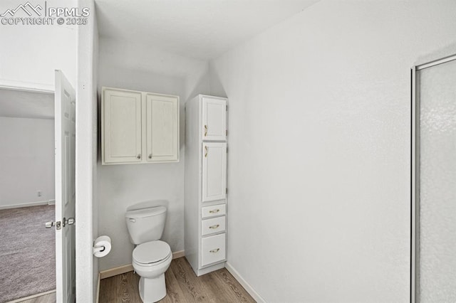 9775 Indian Village Hts, Fountain, CO 80817 - bathroom featuring wood finished floors, baseboards, and toilet