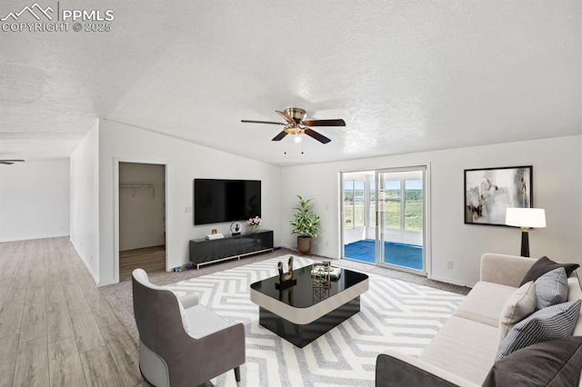 9775 Indian Village Hts, Fountain, CO 80817 - living area with ceiling fan, a textured ceiling, vaulted ceiling, light wood-type flooring, and baseboards