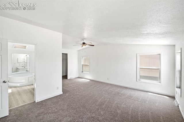 9775 Indian Village Hts, Fountain, CO 80817 - unfurnished living room with carpet floors, a ceiling fan, a textured ceiling, baseboards, and vaulted ceiling