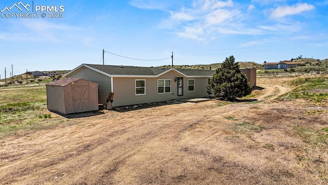 9775 Indian Village Hts, Fountain, CO 80817 - back of property with a storage unit and an outdoor structure