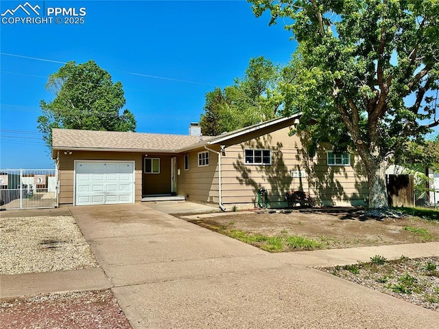 1701 Jerry Murphy Rd, Pueblo, CO 81001 - ranch-style house featuring a garage, concrete driveway, fence, and a chimney