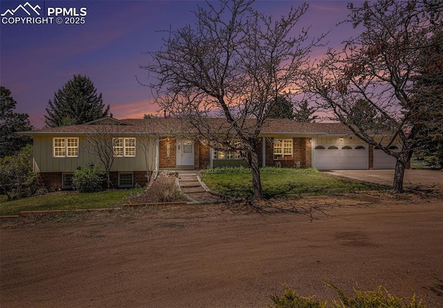 7210 Antelope Ln, Colorado Springs, CO 80920 - view of front of home with driveway, brick siding, a garage, and a yard