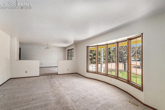 7210 Antelope Ln, Colorado Springs, CO 80920 - carpeted spare room with a chandelier, healthy amount of natural light, and baseboards