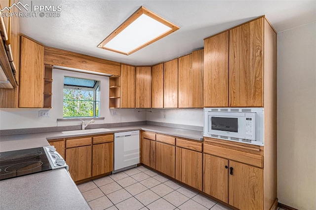 7210 Antelope Ln, Colorado Springs, CO 80920 - kitchen with white appliances, open shelves, a sink, light countertops, and light tile patterned floors