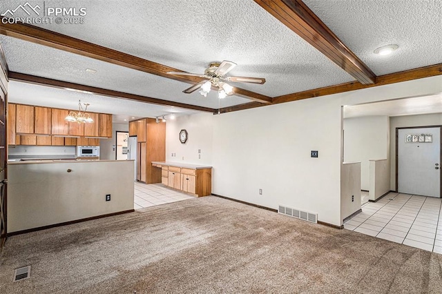 7210 Antelope Ln, Colorado Springs, CO 80920 - unfurnished living room with a textured ceiling, light tile patterned flooring, light colored carpet, beam ceiling, and a ceiling fan