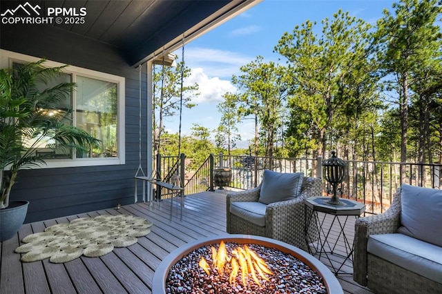 wooden deck with a fire pit