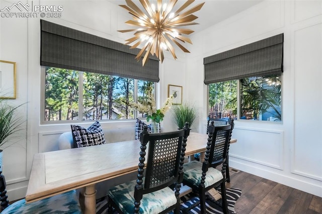 dining space featuring a chandelier, dark wood finished floors, and plenty of natural light
