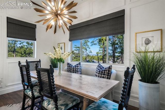 dining area featuring wood finished floors and a chandelier