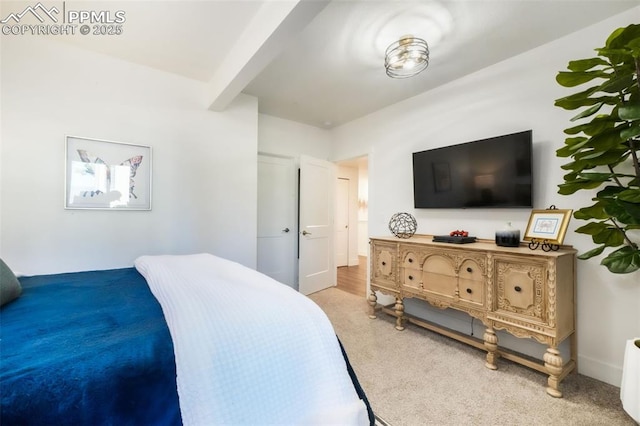 bedroom with carpet flooring and beam ceiling