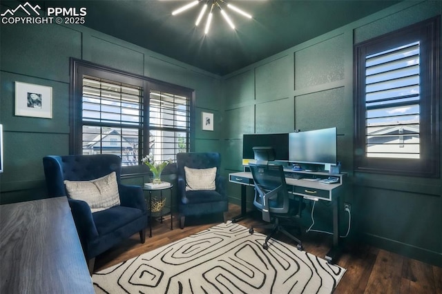 office area with a decorative wall, wood finished floors, and healthy amount of natural light