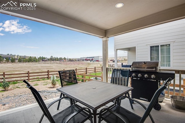 16470 Mountain Flax Dr, Monument, CO 80132 - view of patio / terrace with fence, a rural view, outdoor dining space, and a grill