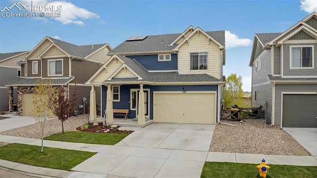 craftsman house featuring a garage, a shingled roof, driveway, and covered porch