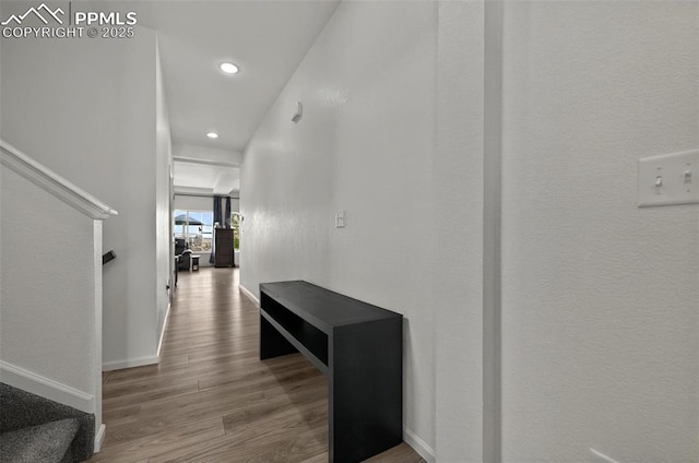 hall featuring wood finished floors, recessed lighting, baseboards, and stairway