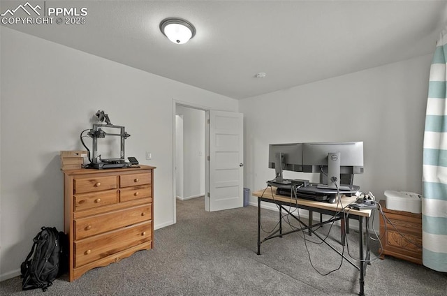 carpeted home office featuring baseboards