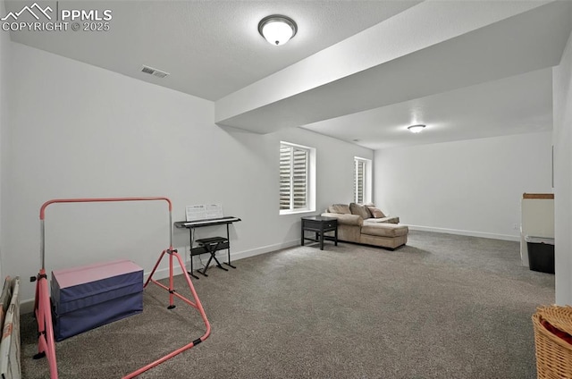 sitting room featuring carpet floors and baseboards