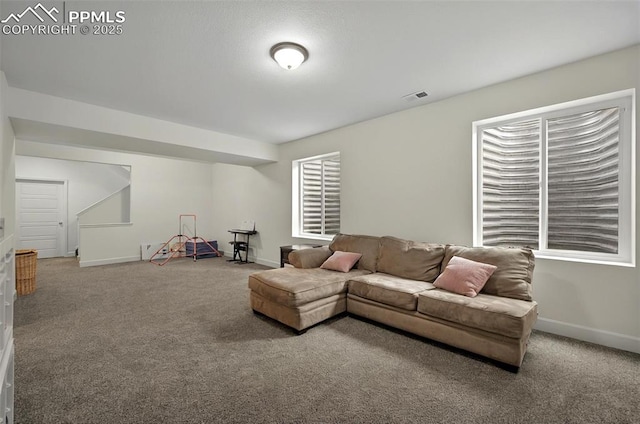 living area featuring carpet flooring and baseboards