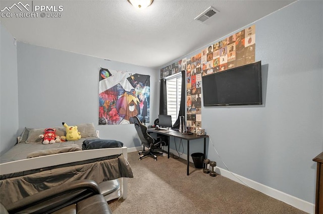 carpeted bedroom with an office area, baseboards, and a textured ceiling