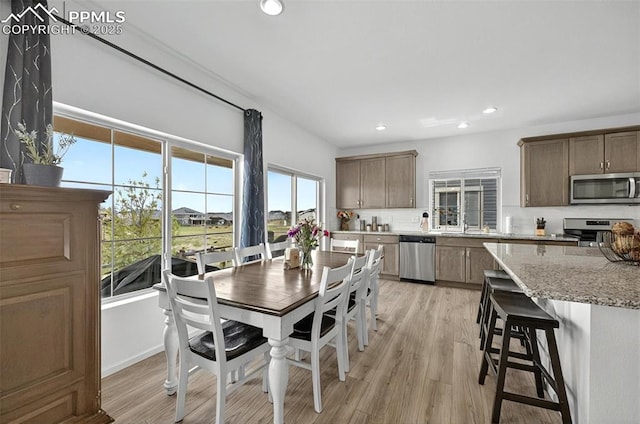 dining room with light wood-type flooring and recessed lighting