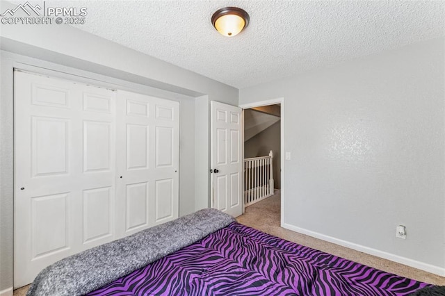 604 Blossom Field Rd, Fountain, CO 80817 - carpeted bedroom featuring a textured ceiling, a closet, and baseboards