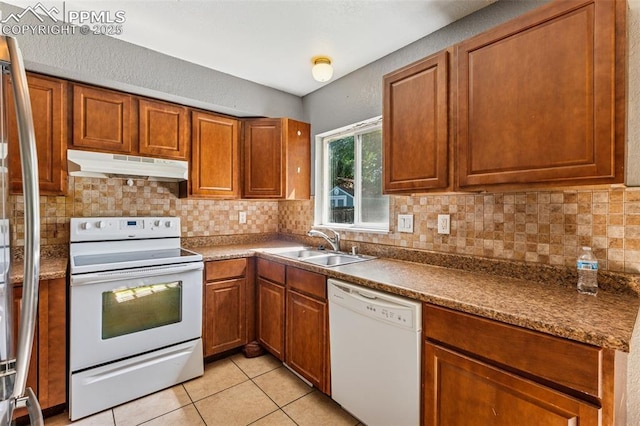 604 Blossom Field Rd, Fountain, CO 80817 - kitchen with white appliances, under cabinet range hood, a sink, and decorative backsplash