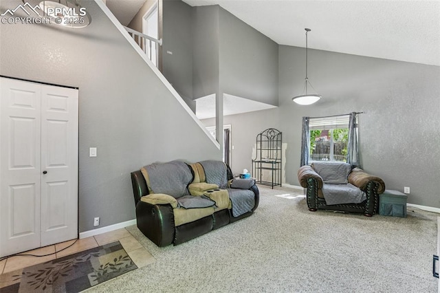604 Blossom Field Rd, Fountain, CO 80817 - living area featuring high vaulted ceiling, stairs, baseboards, and carpet