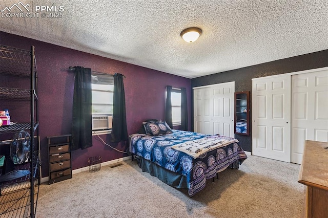 604 Blossom Field Rd, Fountain, CO 80817 - bedroom featuring carpet flooring, multiple closets, a textured ceiling, and cooling unit
