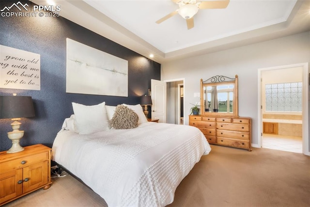 bedroom with carpet flooring, ensuite bath, and a ceiling fan