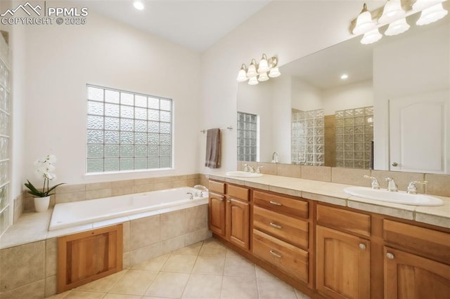 bathroom with a bath, tile patterned floors, and double vanity