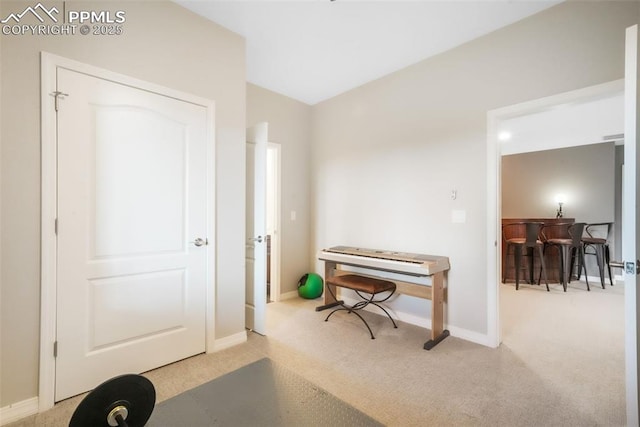 carpeted entrance foyer with baseboards