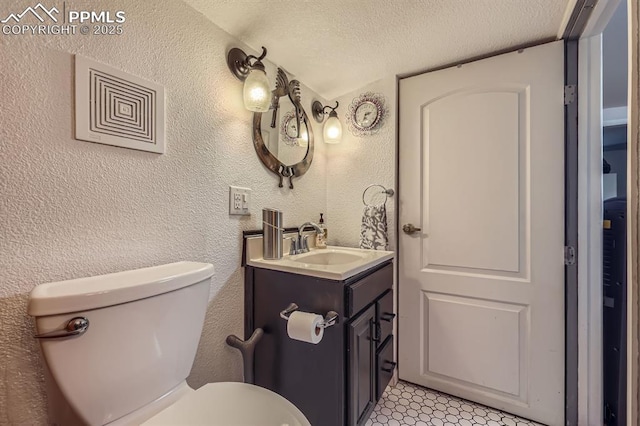 319 S Institute St, Colorado Springs, CO 80903 - half bathroom with toilet, a textured ceiling, vanity, and a textured wall