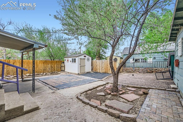 319 S Institute St, Colorado Springs, CO 80903 - view of patio featuring a shed, a fenced backyard, and an outbuilding